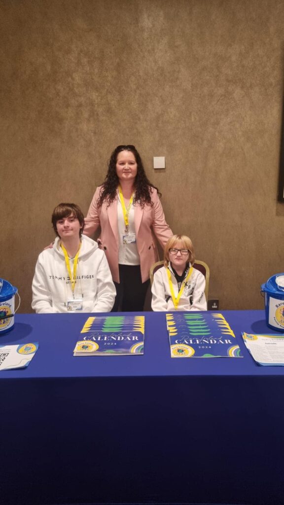 Erica-OMeara-Jack-Kalven-selling-calanders-and-welcoming-people-to-the-conference-2023