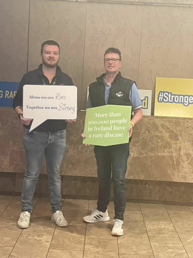 Two-attendees-holding-Rare-Ireland-Banners-at-the-Conference-2023