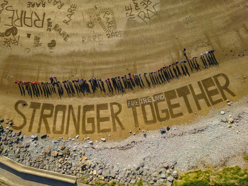 Beach ariel view with the sand art stronger togther
